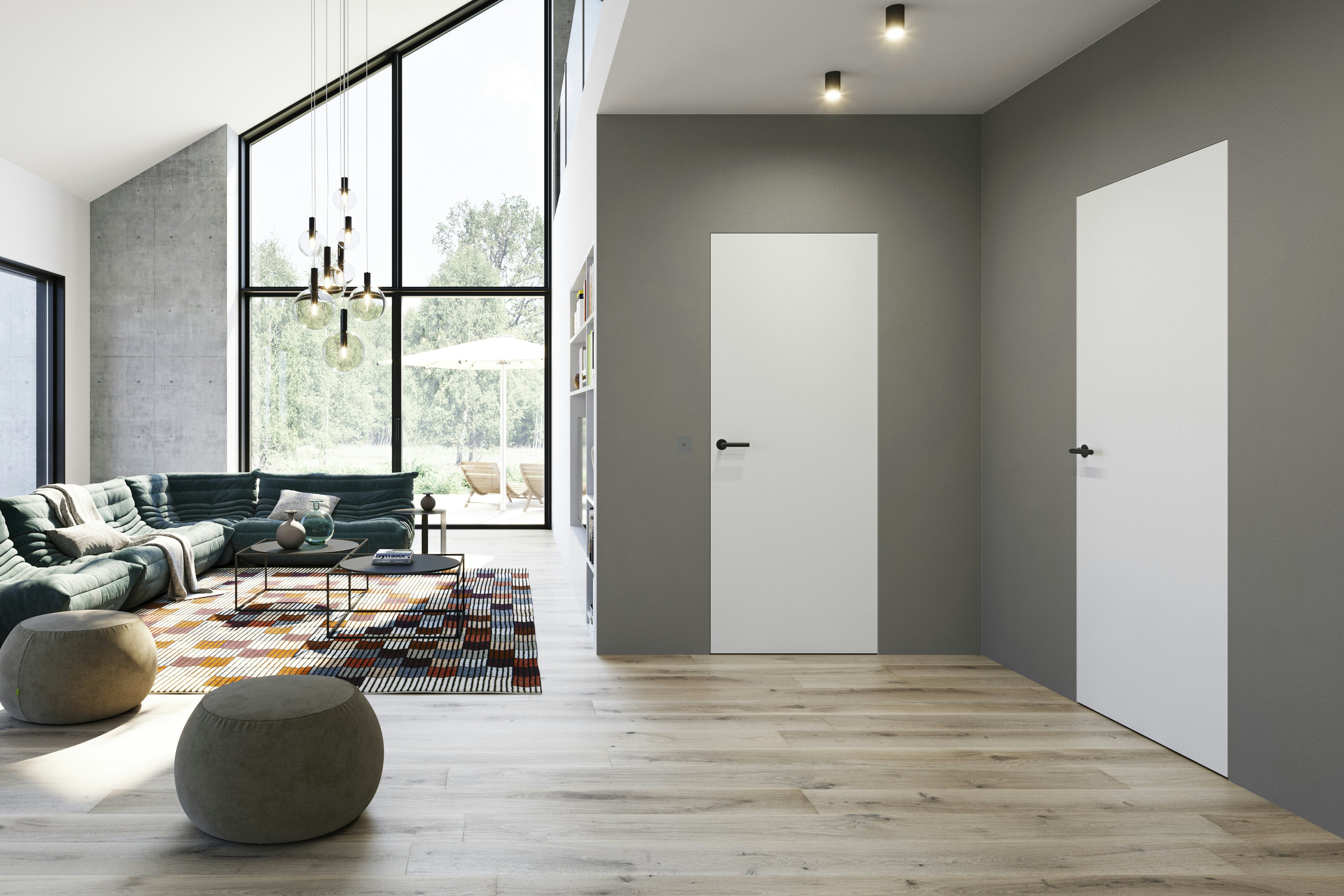 Die vollständig verputzte Zeroline Zarge sorgt für absolute Flächenbündigkeit. In Kombination mit einem stumpf einschlagenden Türblatt und verdeckt liegenden Bändern verschmelzen die Türen so optisch mit der Wand.