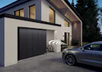 Maak het gebruik van uw garagedeur nog gemakkelijker met de... Zilveren auto geparkeerd voor moderne woning met een Hörmann garage.