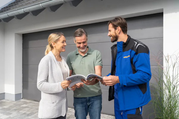 Hörmann monteur praat met 2 klanten voor een sectionale garagedeur
