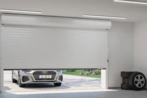 Eleelektrische garagedeur | Garageroldeur Hörmann Een auto wacht voor een opengaande elektrische garagedeur van Hörmann. Dit is een garageroldeur.