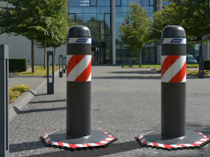 The OktaBlock mobile vehicle barrier secures access to event... The OktaBlock mobile vehicle barrier secures access to event venues. One of its key features is the octagonal base plate with a serrated edge. In the event of a vehicle impact, the bollard tips...